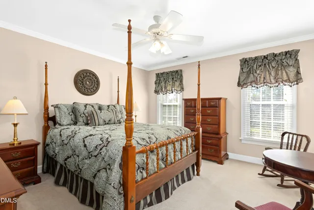 a bedroom with furniture and a large window