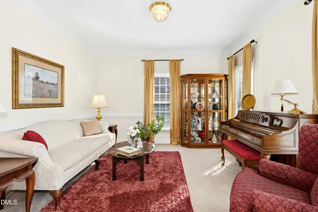 a living room with furniture a rug and a window
