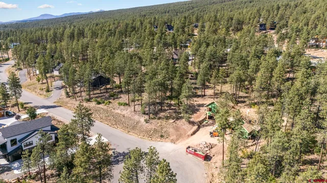 a view of a yard with wooden fence