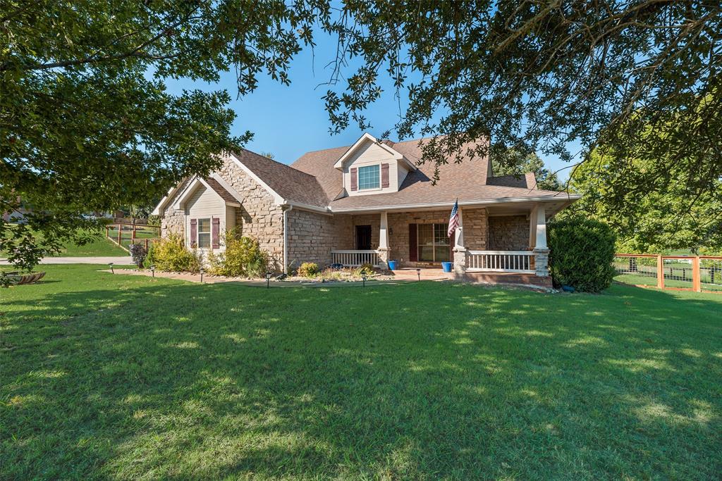 82 Trail Ridge Drive Melissa, TX 75454 - Photo 2 of 29 Curb appeal galore with stone structure, large front yard and wrap-around front porch