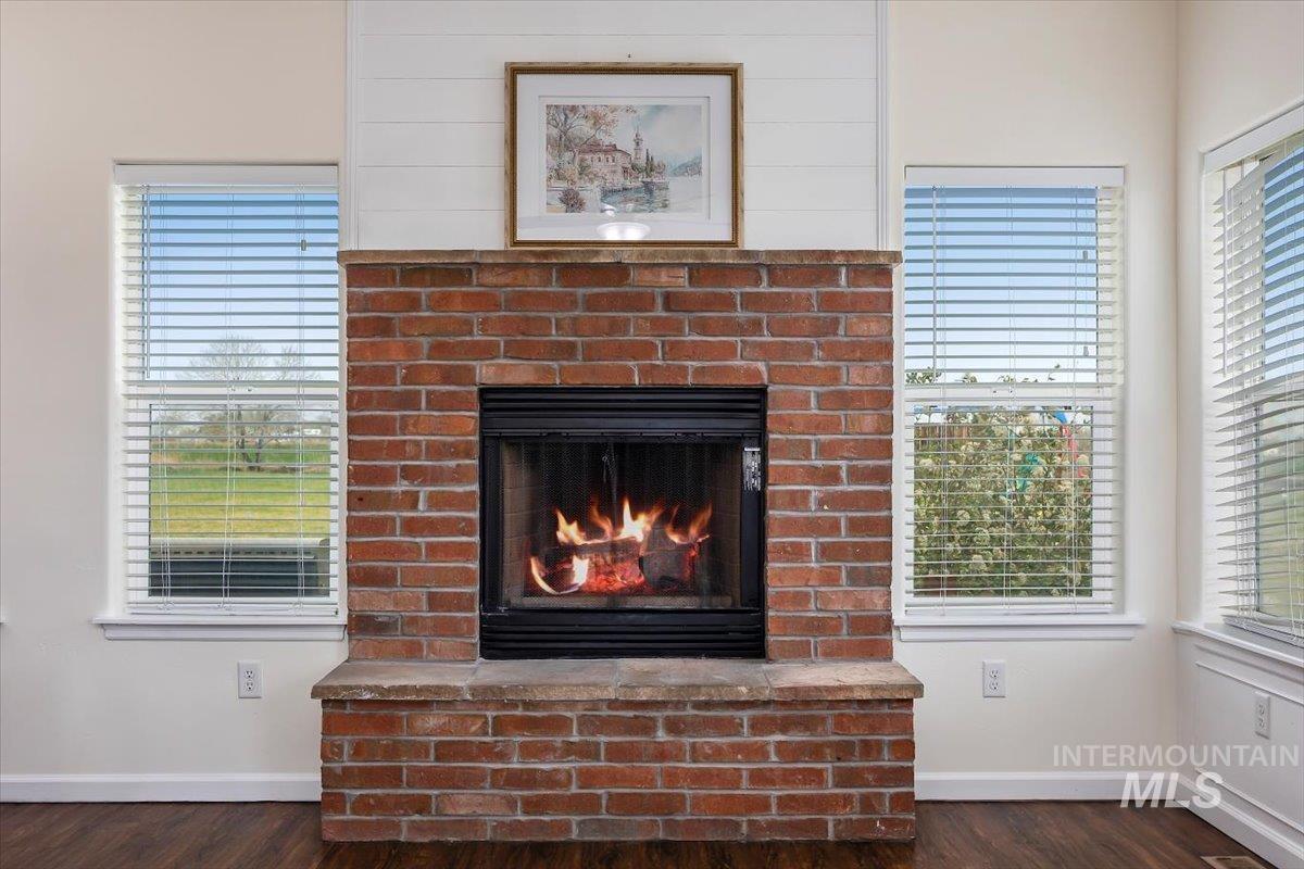 3813 North 2456 East Filer, ID 83328 - Photo 14 of 50 Detailed view of a brick fireplace and wood finished floors