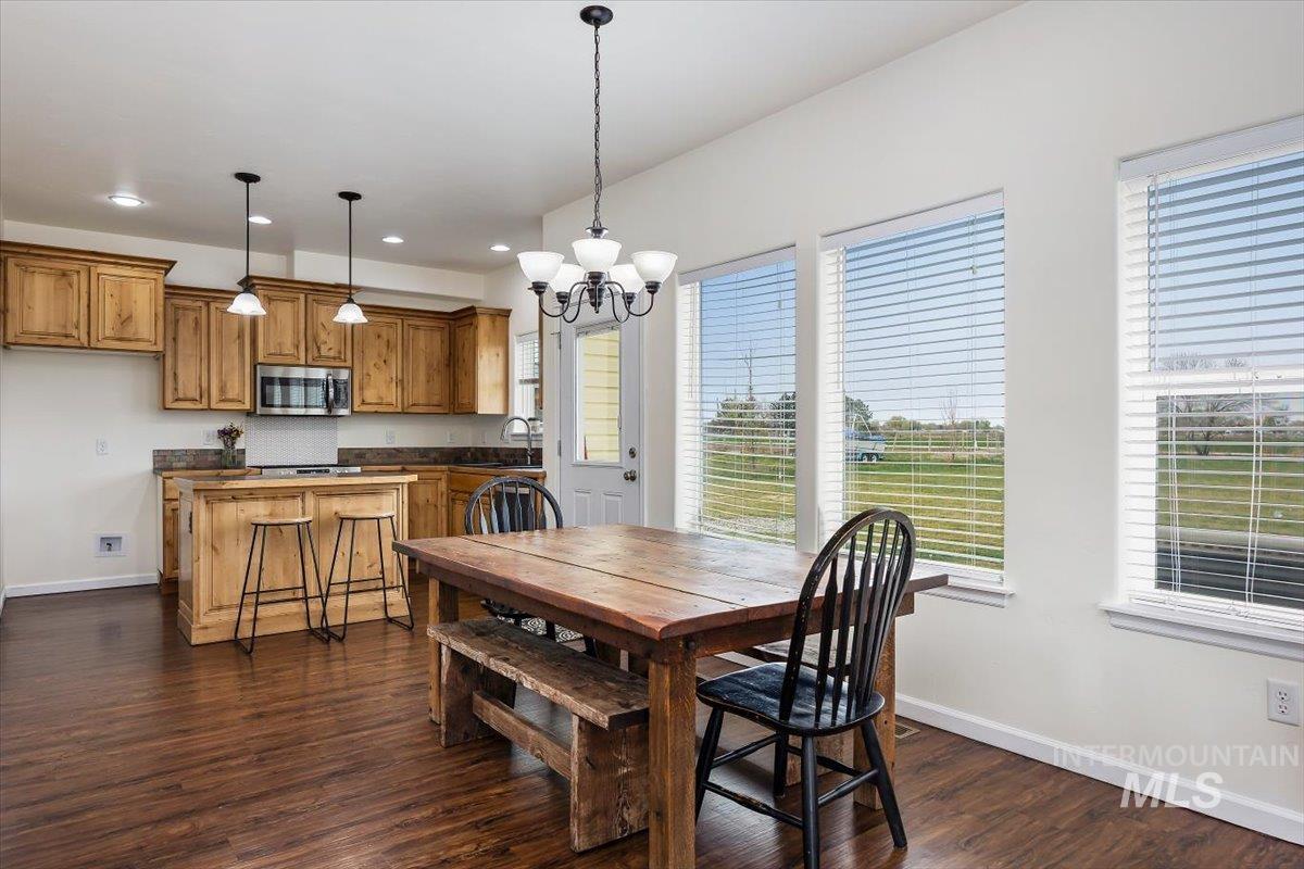 3813 North 2456 East Filer, ID 83328 - Photo 15 of 50 Dining space with dark wood-style flooring and suspended lighting