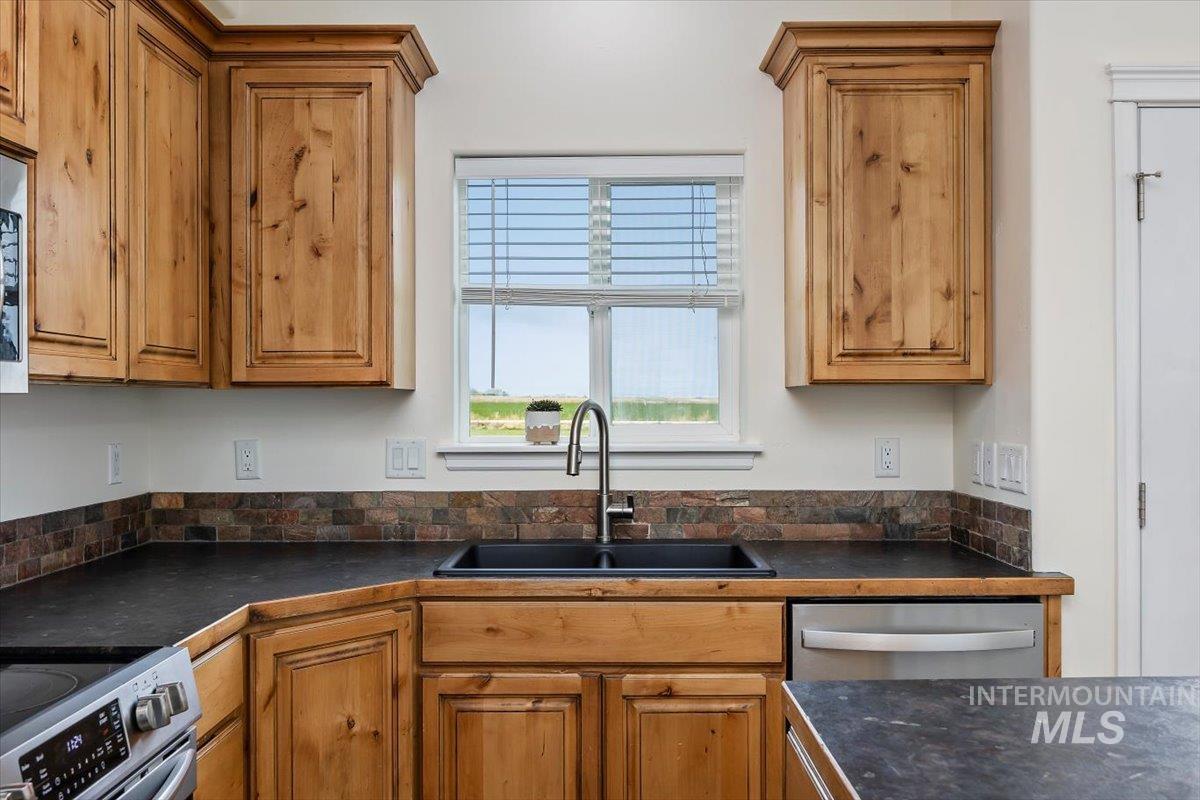 3813 North 2456 East Filer, ID 83328 - Photo 22 of 50 Kitchen with dark countertops, wood finish cabinets, and stainless steel appliances