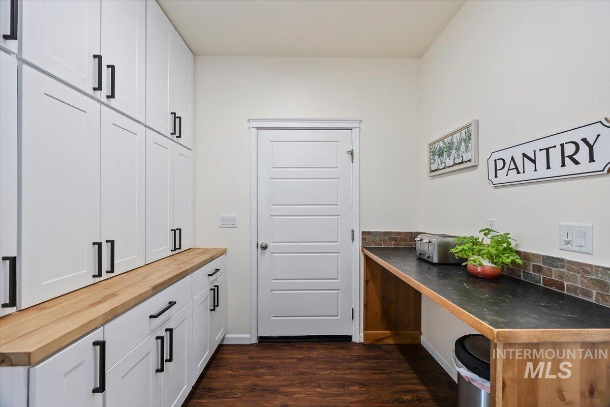 3813 North 2456 East Filer, ID 83328 - Photo 26 of 50 Interior space with butcher block counters, dark wood finished floors, and white cabinetry