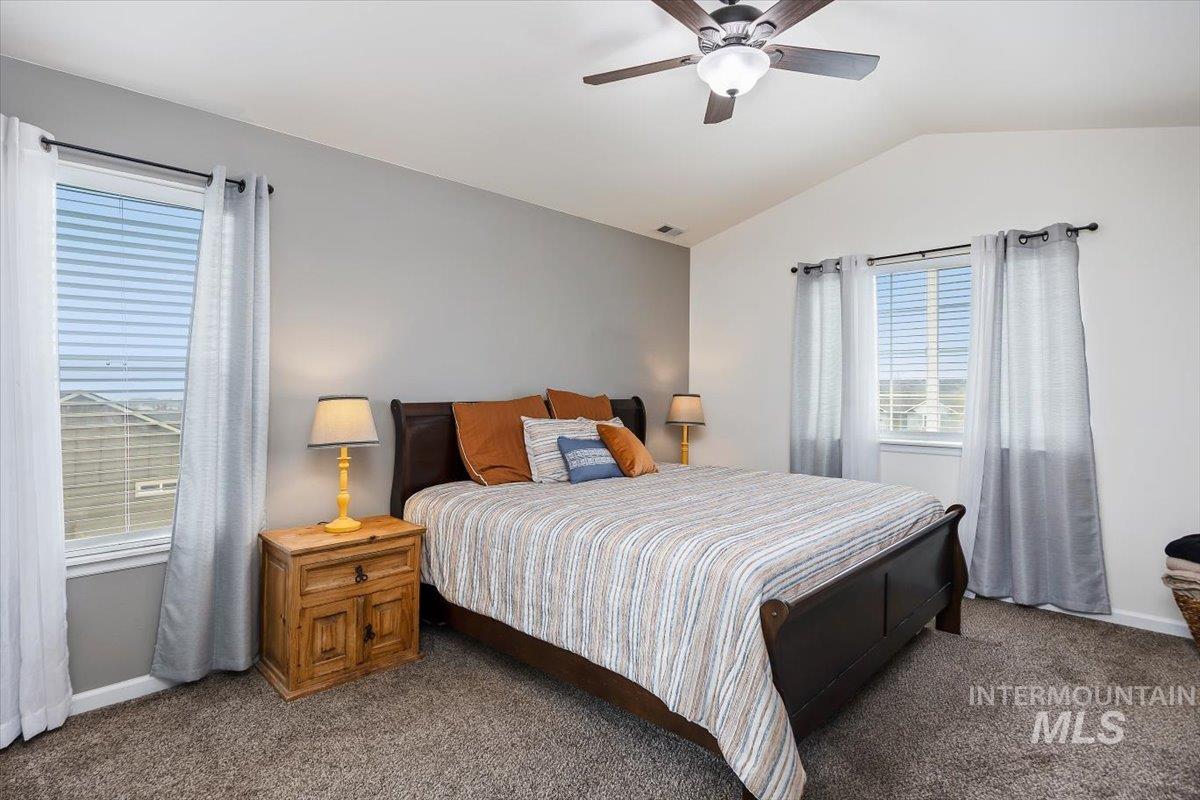 3813 North 2456 East Filer, ID 83328 - Photo 27 of 50 Bedroom with vaulted ceiling, dark colored carpet, and ceiling fan