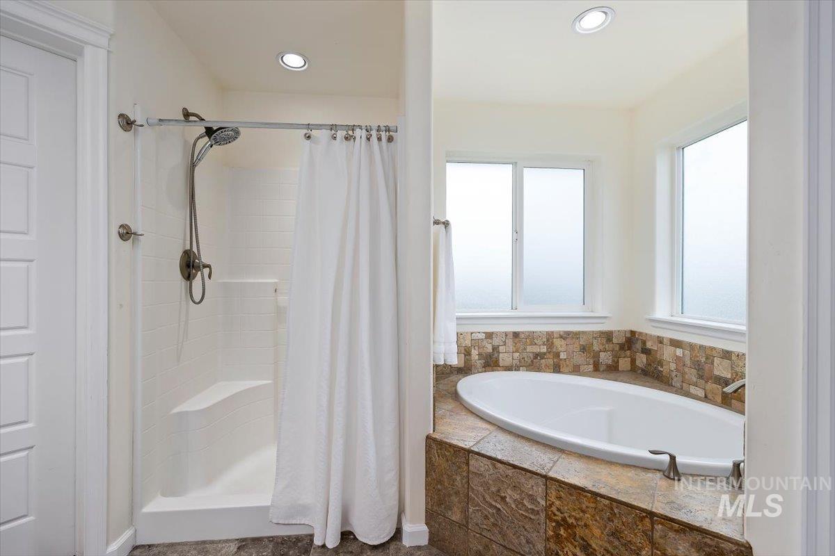 3813 North 2456 East Filer, ID 83328 - Photo 29 of 50 Bathroom featuring a shower stall, a garden tub, and recessed lighting