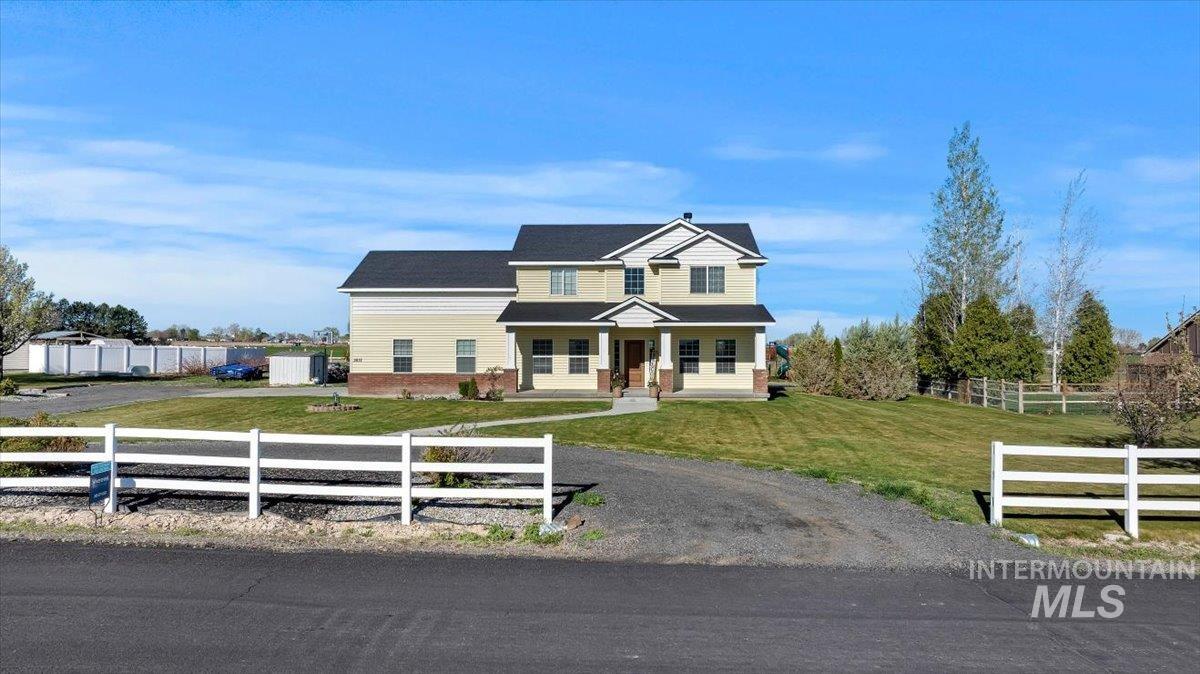3813 North 2456 East Filer, ID 83328 - Photo 3 of 50 View of front of home with covered porch and a fenced front yard