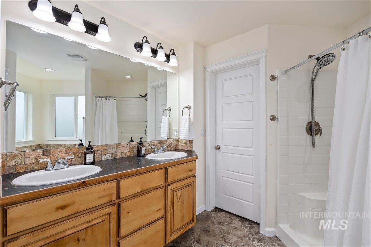 3813 North 2456 East Filer, ID 83328 - Photo 31 of 50 Bathroom featuring double vanity and a stall shower