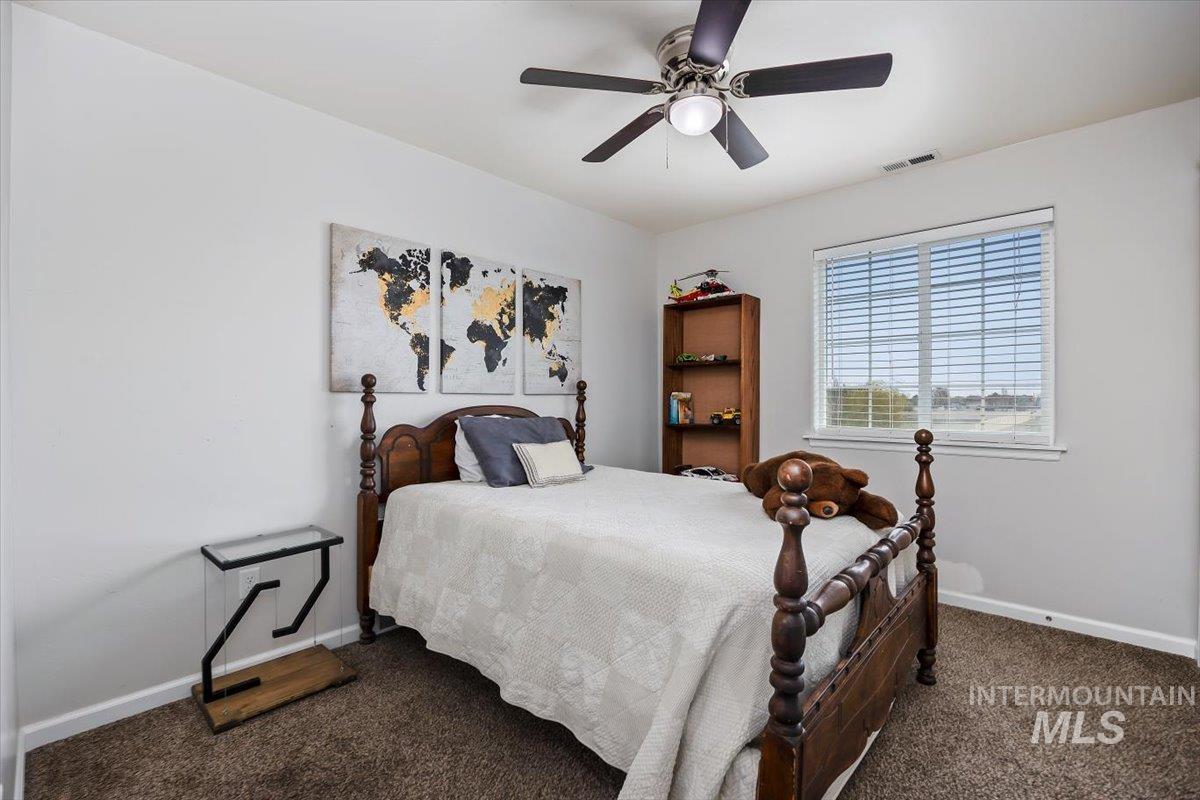 3813 North 2456 East Filer, ID 83328 - Photo 33 of 50 Bedroom with a ceiling fan and carpet flooring