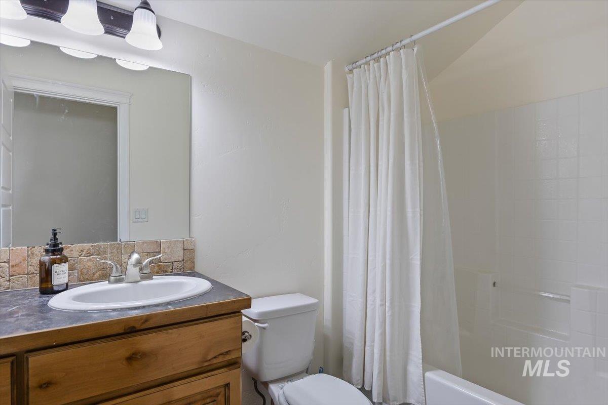 3813 North 2456 East Filer, ID 83328 - Photo 34 of 50 Bathroom featuring vanity and shower / tub combo with curtain