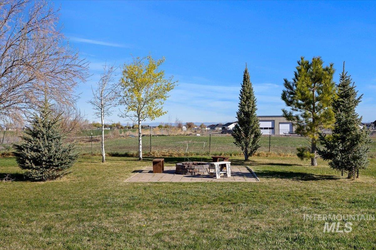3813 North 2456 East Filer, ID 83328 - Photo 44 of 50 View of grassy yard featuring a patio area and an outdoor fire pit