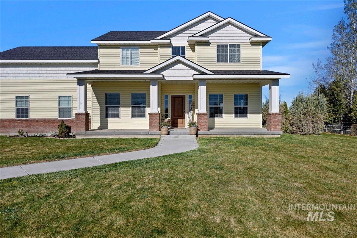 3813 North 2456 East Filer, ID 83328 - Photo 7 of 50 Craftsman-style home with brick siding, a porch, a front yard, and a shingled roof