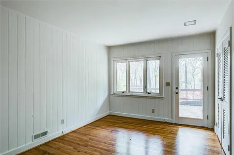 wooden floor in an empty room with a window