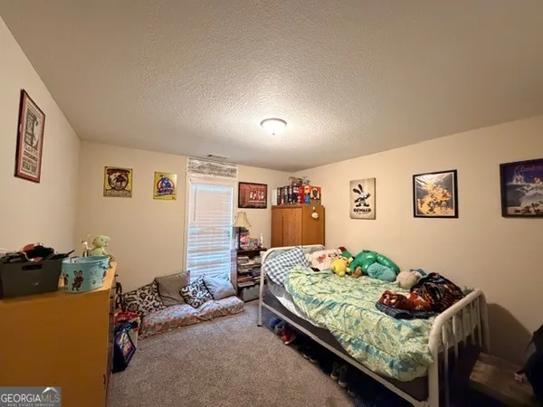 a bedroom with bed and a couch