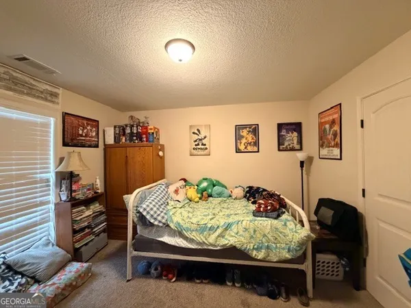 a bedroom with furniture and a bed