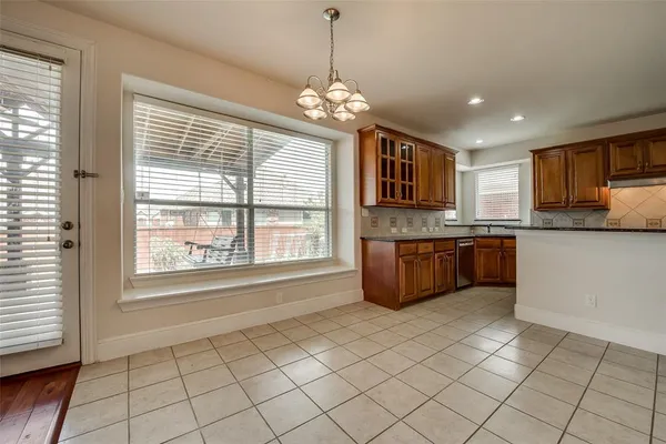 a open kitchen with granite countertop a stove sink and cabinets