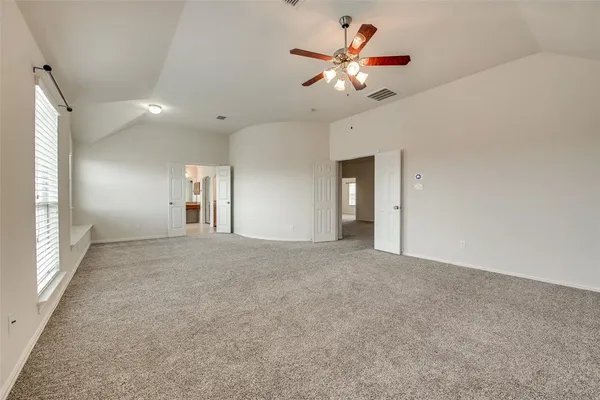 wooden floor in an empty room with a chandelier fan