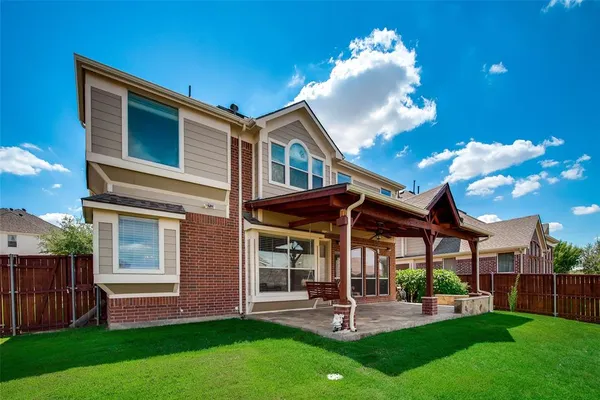a view of a house with backyard porch and sitting area