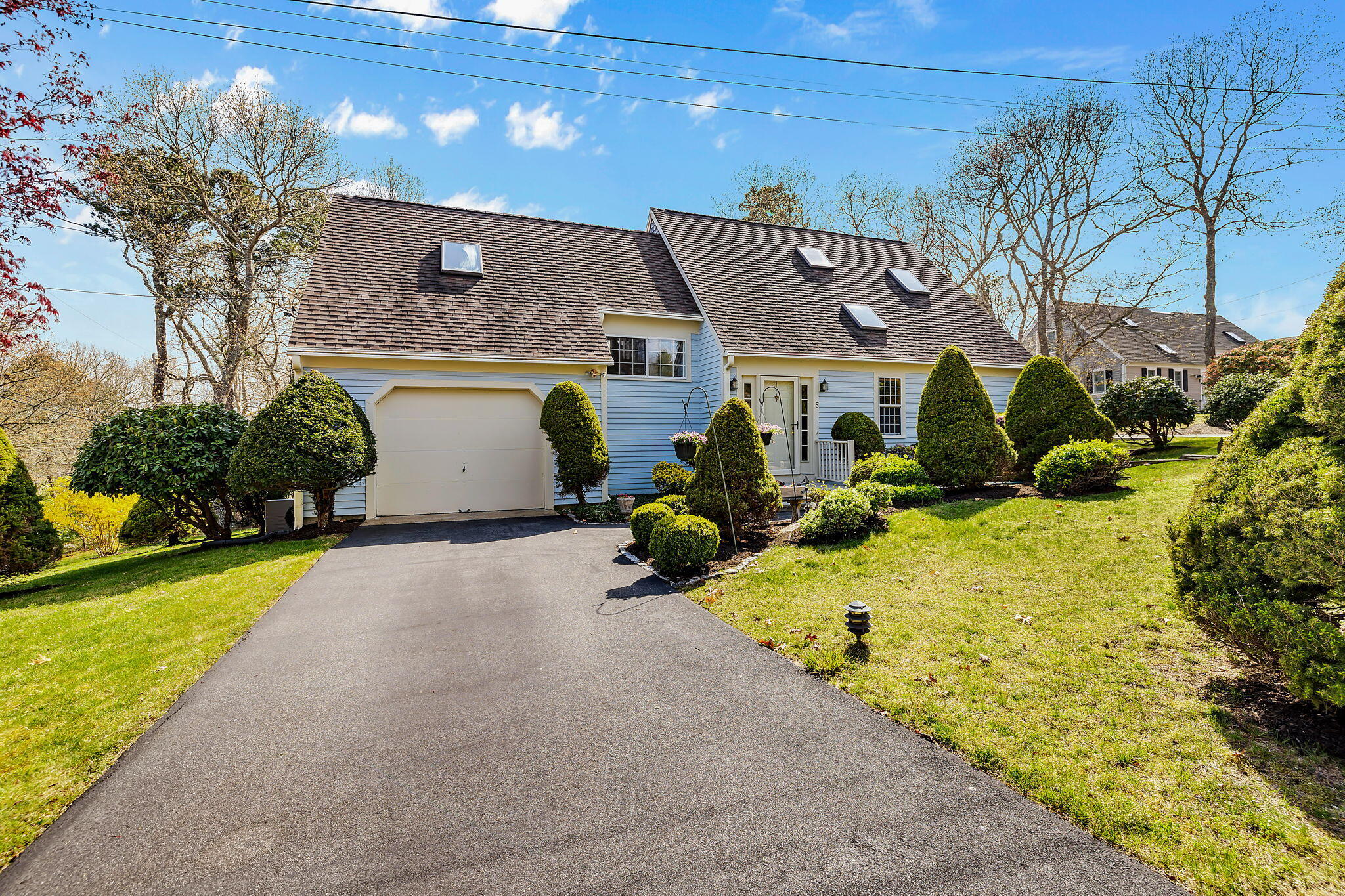 5 Vista Circle Centerville, MA 02632 - Photo 2 of 43 a front view of a house with a yard and garage