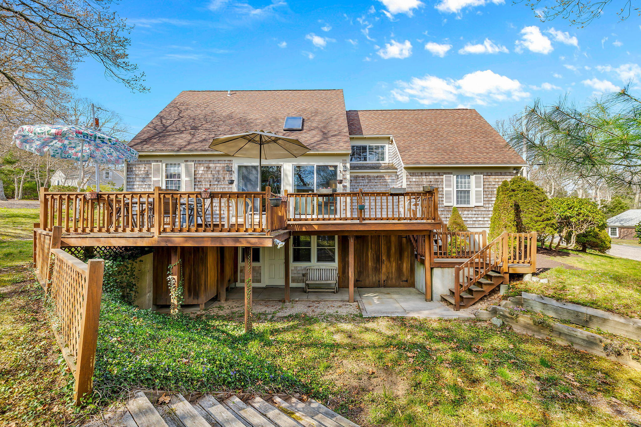 5 Vista Circle Centerville, MA 02632 - Photo 33 of 43 a front view of a house with a yard patio and fire pit