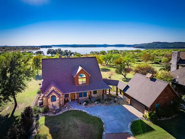 an aerial view of a house with swimming pool patio and outdoor seating