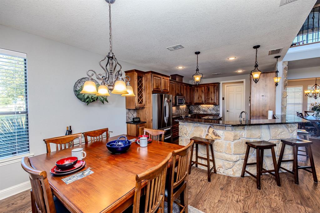 401 Frog Branch Court Graford, TX 76449 - Photo 14 of 40 a view of a dining room with furniture and chandelier