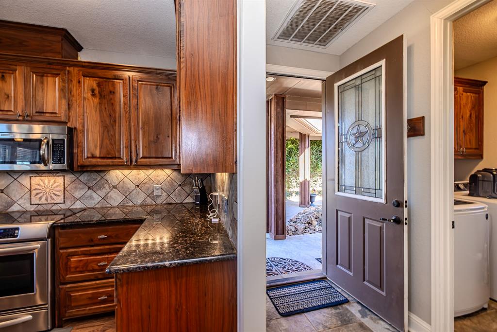 401 Frog Branch Court Graford, TX 76449 - Photo 16 of 40 a kitchen with a refrigerator and a stove top oven