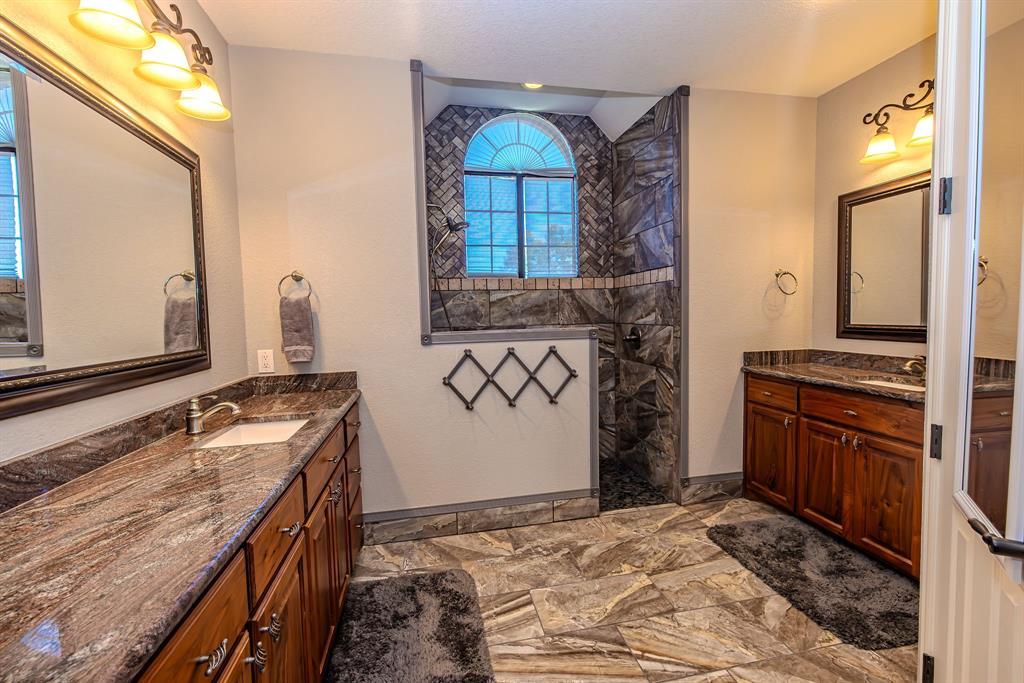 401 Frog Branch Court Graford, TX 76449 - Photo 21 of 40 a bathroom with a sink and a mirror