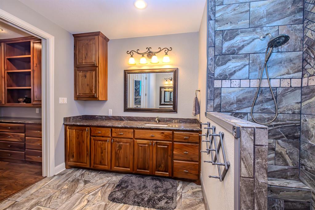 401 Frog Branch Court Graford, TX 76449 - Photo 23 of 40 a bathroom with a sink and a mirror