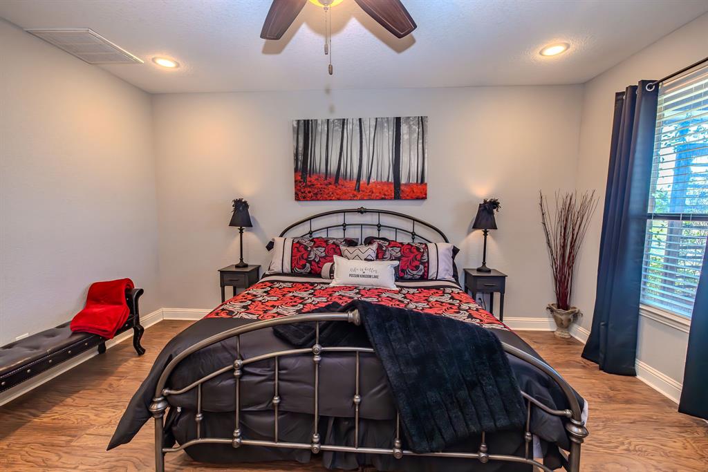 401 Frog Branch Court Graford, TX 76449 - Photo 25 of 40 a bedroom with a bed and a chandelier