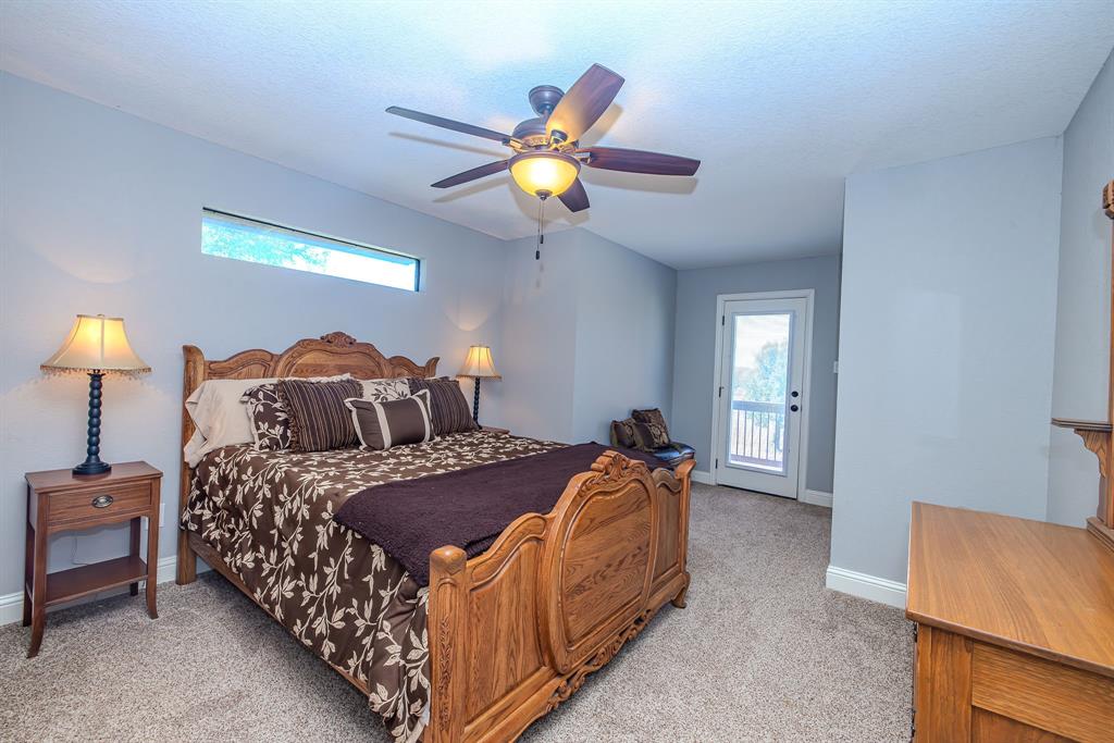 401 Frog Branch Court Graford, TX 76449 - Photo 26 of 40 a bedroom with a bed and a couch