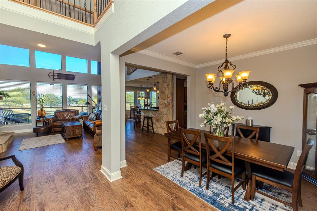 401 Frog Branch Court Graford, TX 76449 - Photo 7 of 40 a view of a dining room with furniture a chandelier and wooden floor