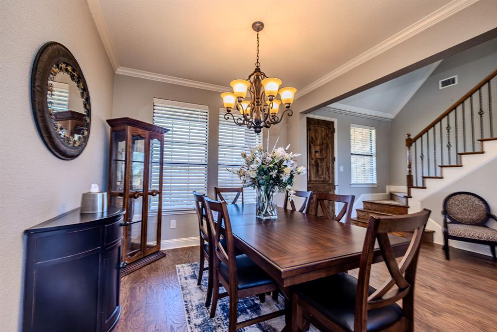 401 Frog Branch Court Graford, TX 76449 - Photo 8 of 40 a dining room with furniture a potted plant and a chandelier