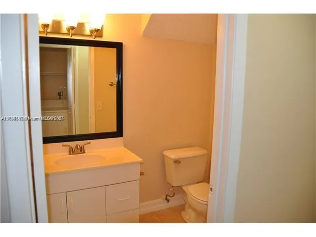 a bathroom with a sink a toilet and mirror