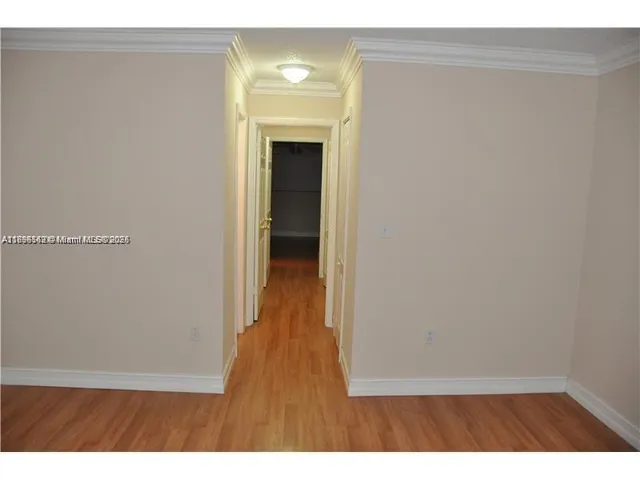 a view of hallway with wooden floor