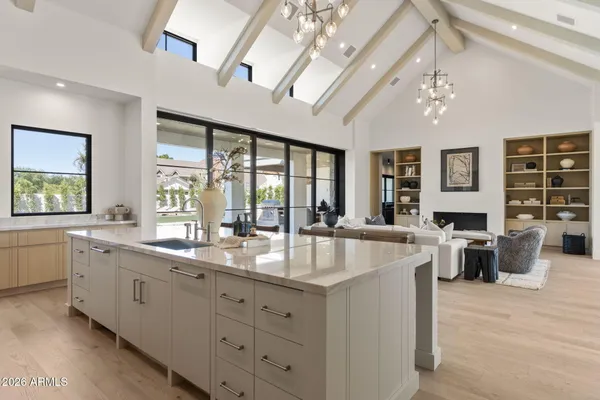a dining room with wooden floor and a chandelier