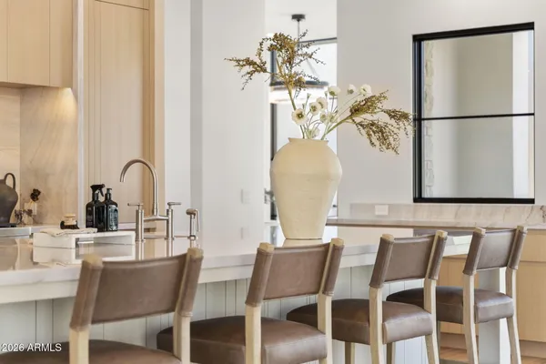 a large white kitchen with a large window