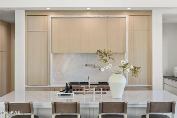 a dining room with furniture and a potted plant