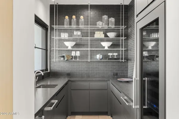 a table with chairs and white cabinets