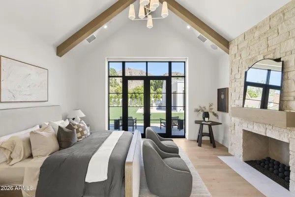 a spacious bedroom with a bed and a large window
