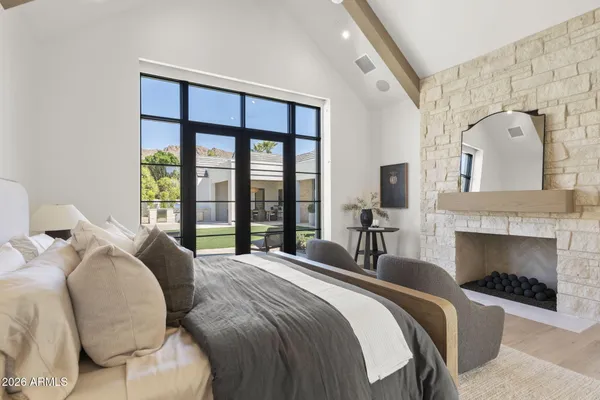 a bedroom with a large bed and a chandelier