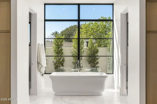 a view of a glass door with a balcony and a chair