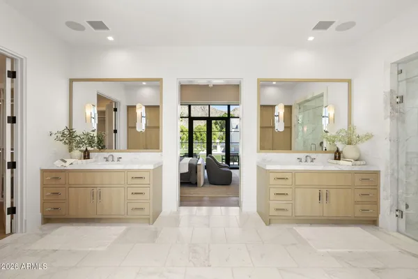 a spacious bathroom with a double vanity sink mirror and bathtub