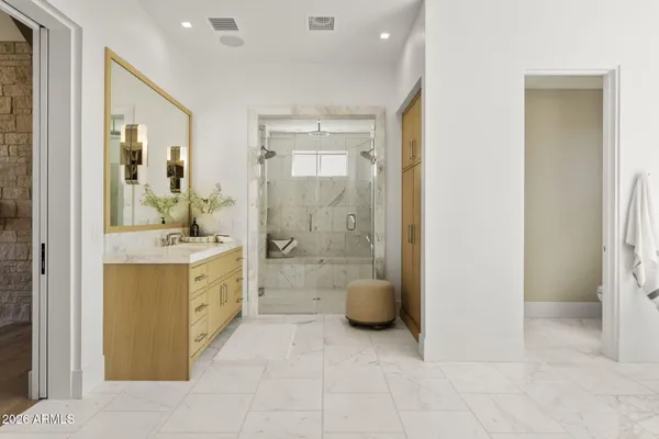 a bathroom with a granite countertop sink a toilet and shower