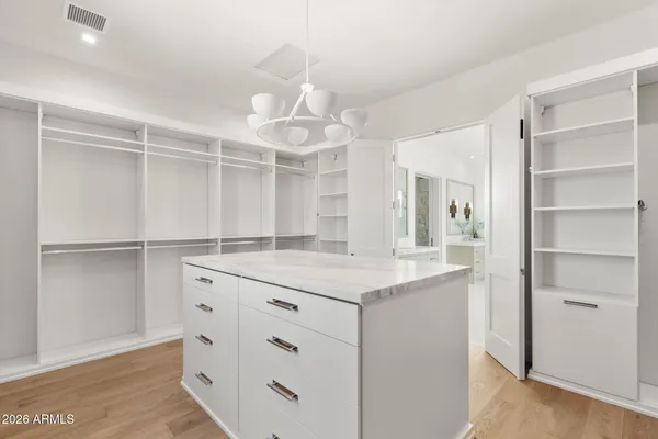 a kitchen with a sink dishwasher a stove and a refrigerator with wooden floor
