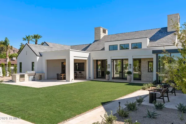a front view of a house with a garden and patio