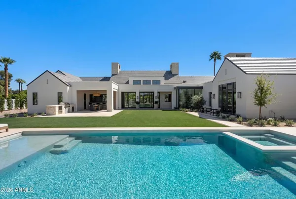 a view of house with a swimming pool