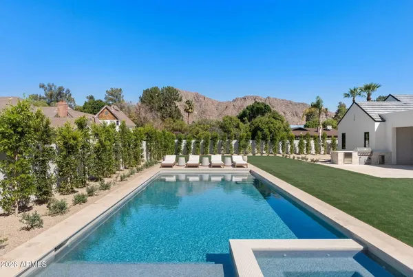 a view of a swimming pool with a yard