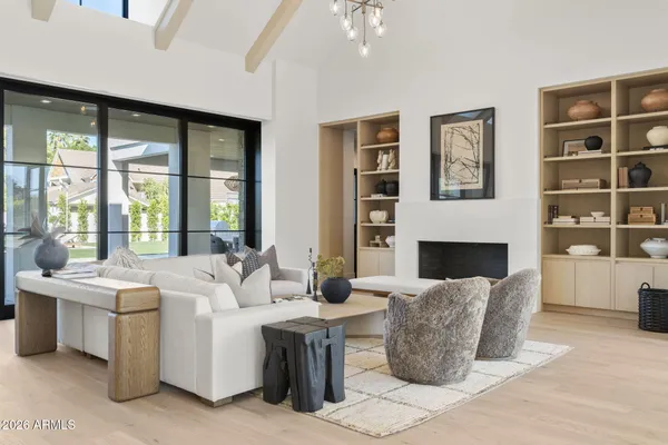 a living room with furniture large window and flat screen tv