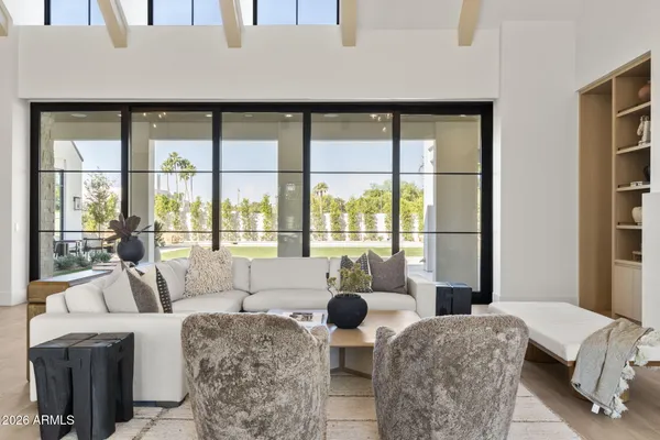 a living room with furniture a fireplace and a large window